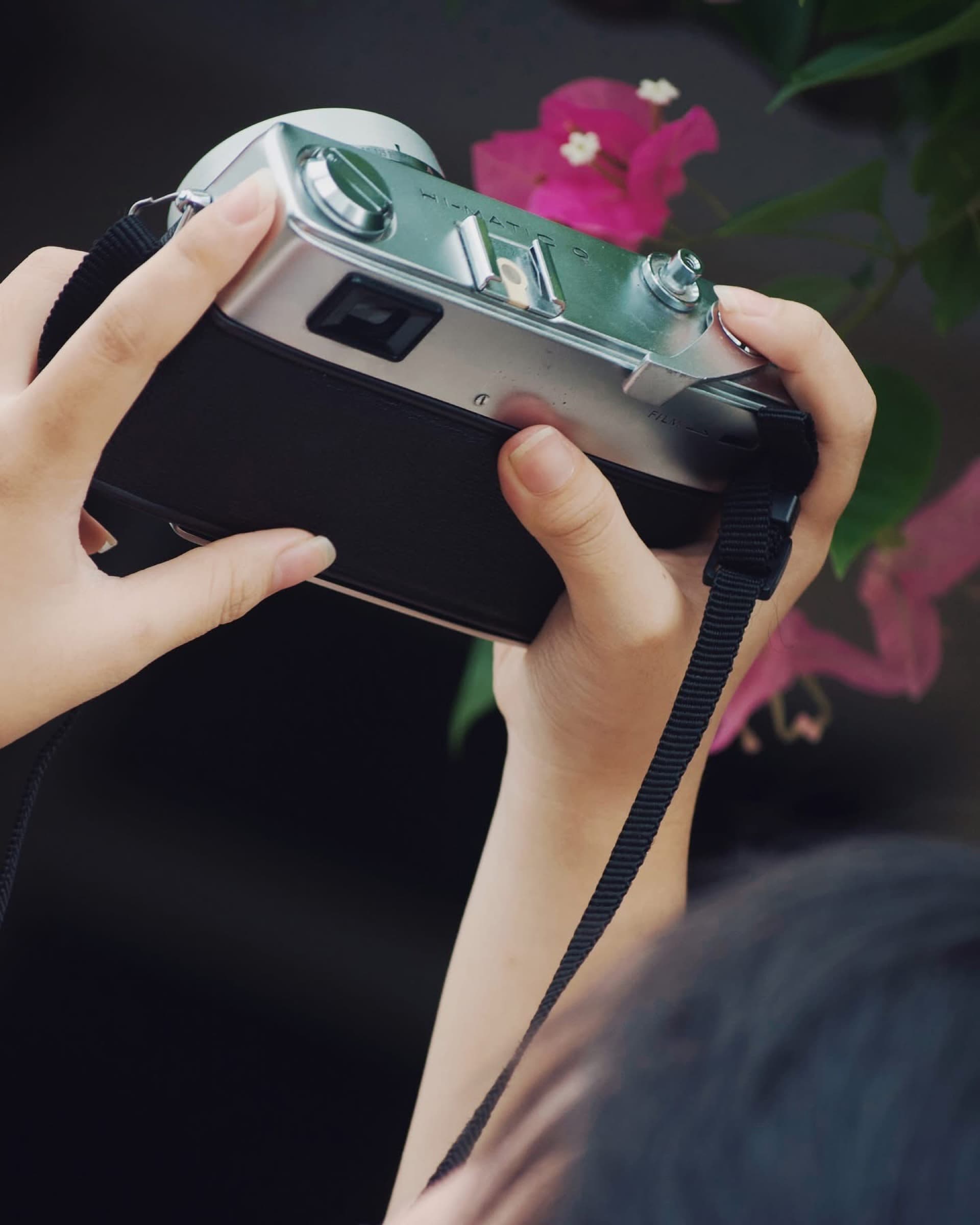 Hands holding a vintage film camera